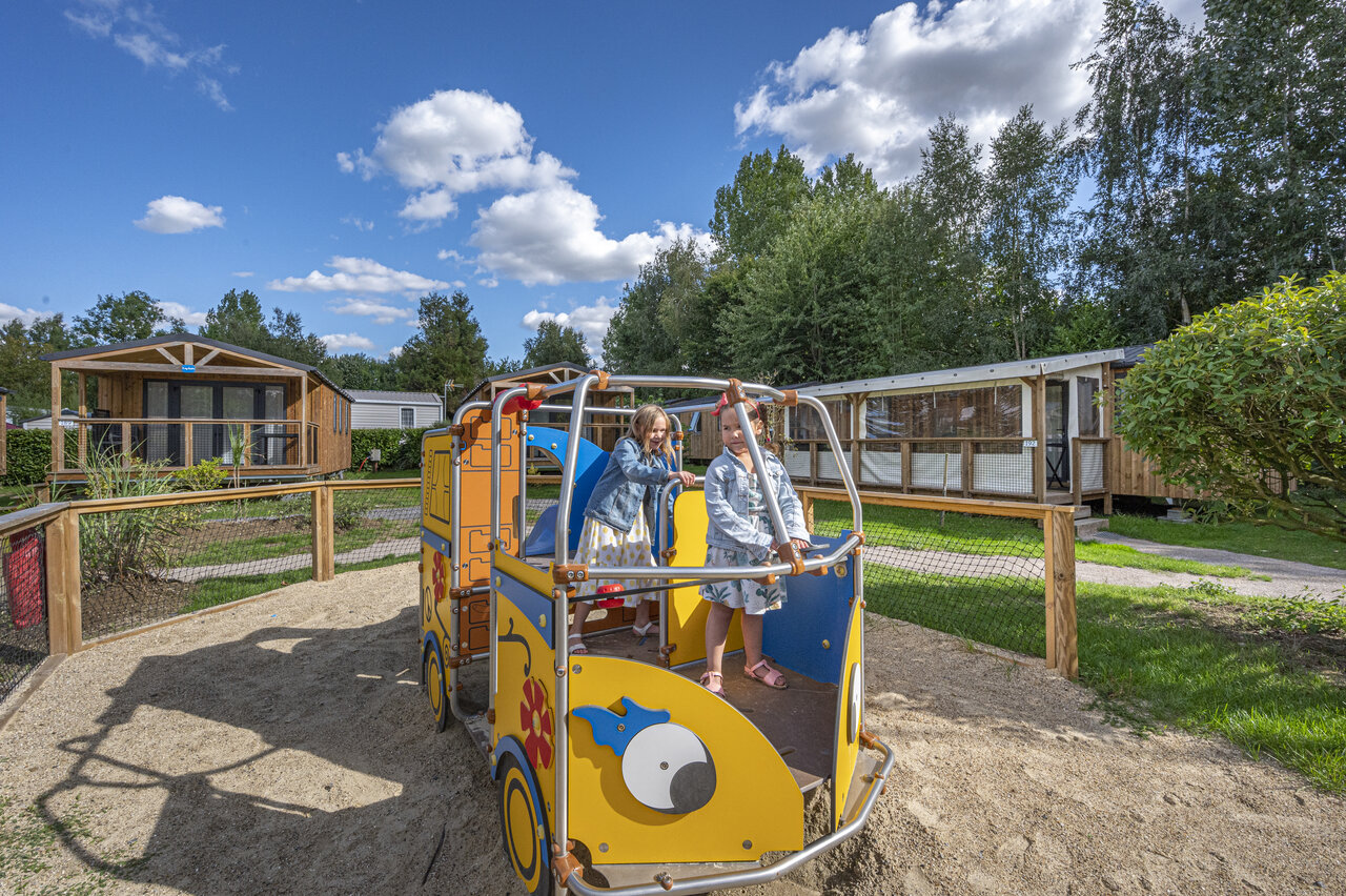 Children playing on playground, Mobile homes at CAPFUN Val d'Authie campsite in Villers sur Authie.