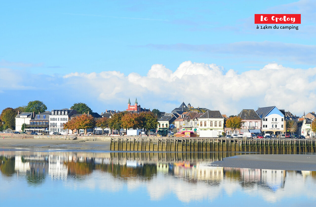 Le Crotoy, charming coastal town with colorful houses and reflections on the water.