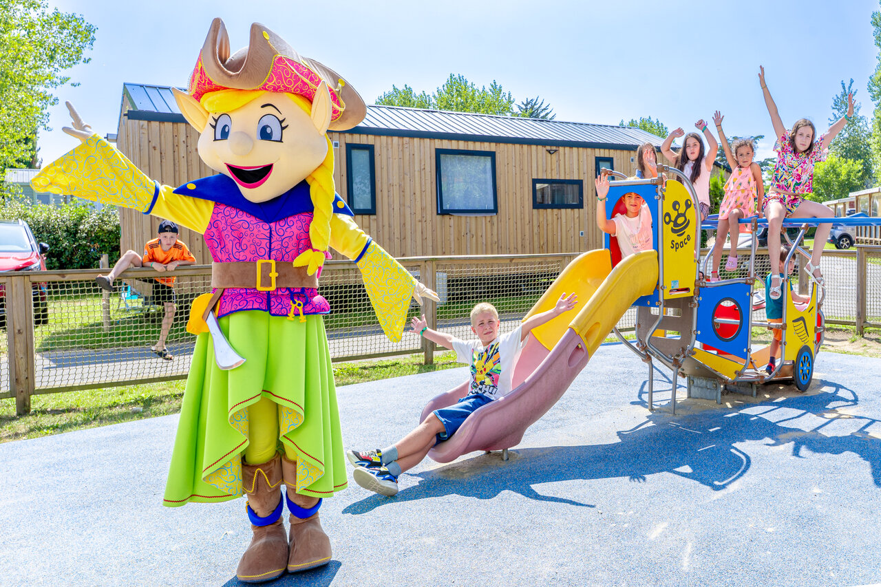 Mascot and happy children on the playground at CAPFUN Vikings campsite in Saint Jean de la Rivi�re.