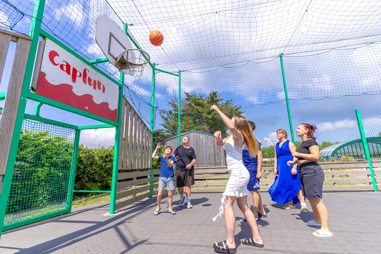 Basketball game on multisport court at CAPFUN Vikings campsite in Saint Jean de la Rivi�re.