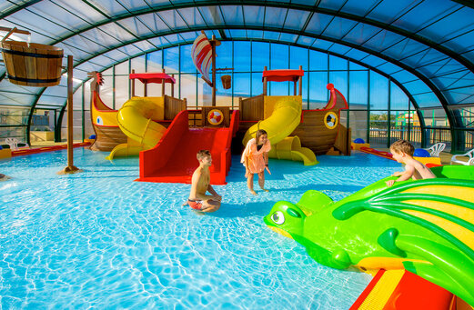 Indoor pool, slides, games at CAPFUN Vikings campsite in Saint Jean de la Rivi�re (50).