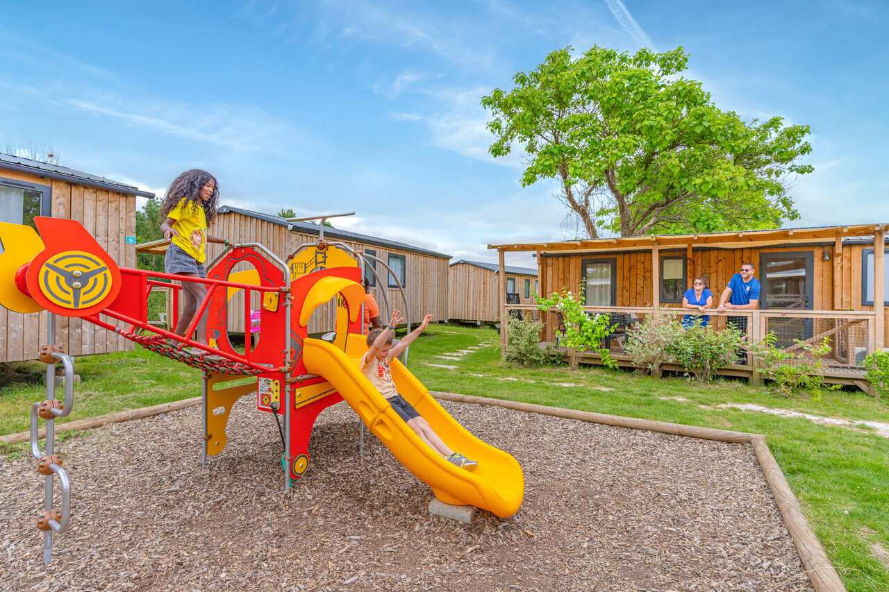 Children's playground, Mobile homes at CAPFUN Le Village Parisien campsite in VARREDDES.