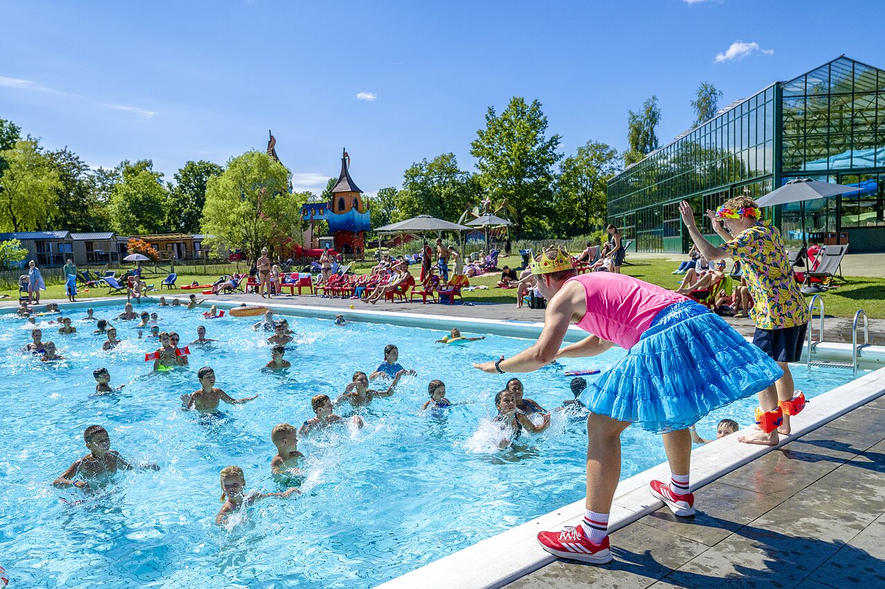 Children enjoying water animation in the outdoor swimming pool at CAPFUN Vlinderloo campsite in Enschede.