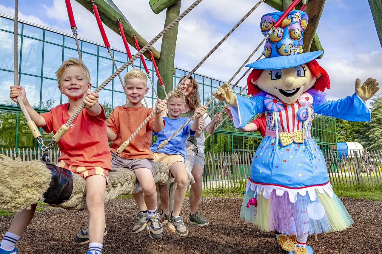 Children and mascot on a giant rope swing at CAPFUN Vlinderloo campsite in Enschede.