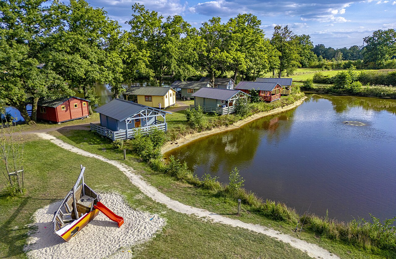 Aerial view Mobil-homes, playground, pond at CAPFUN Vlinderloo campsite in Enschede.
