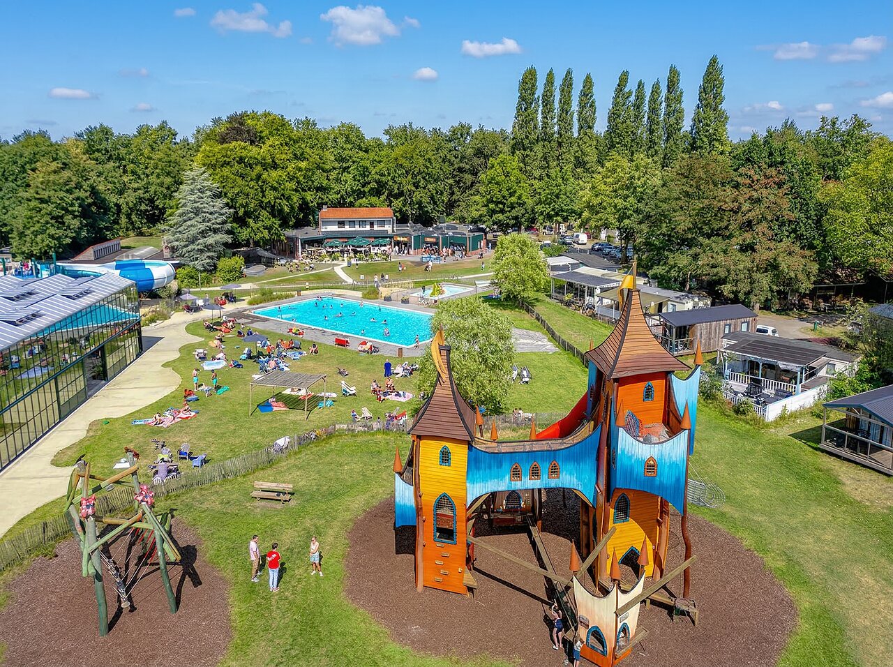 Large castle playground, outdoor and indoor pools at CAPFUN Vlinderloo campsite Enschede.