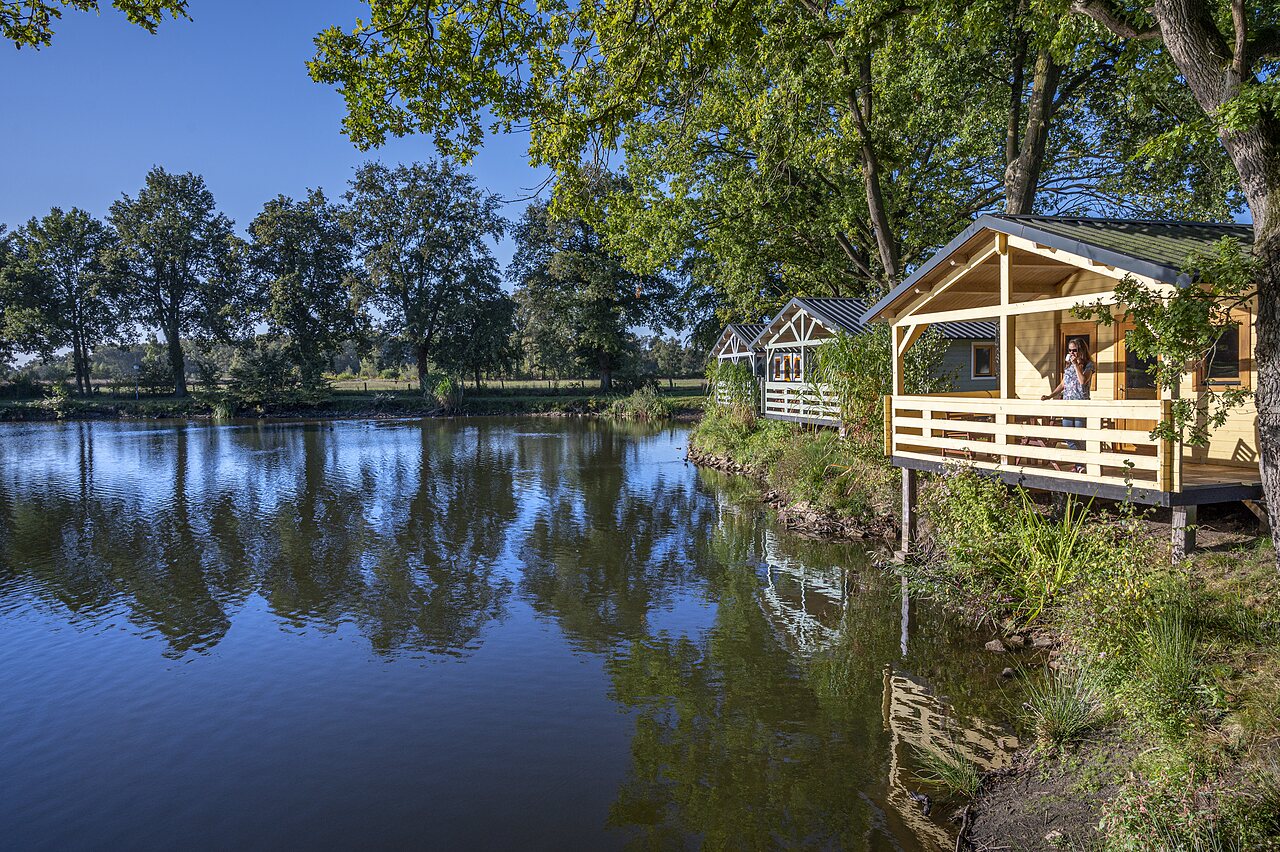 Wooden Mobile-homes lake at CAPFUN Vlinderloo campsite in Enschede.