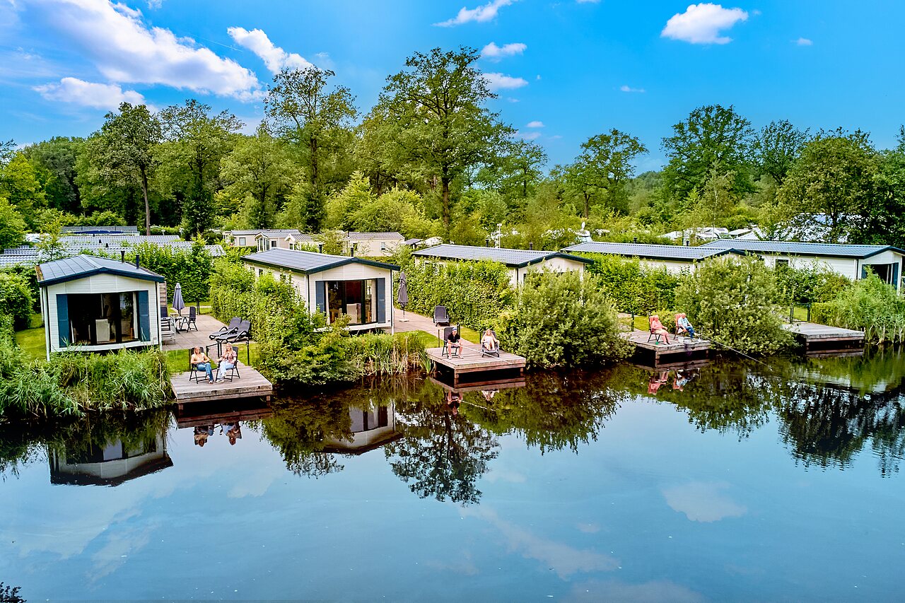 Modern mobile homes with waterside terraces at CAPFUN De Waldsang campsite, Bakkeveen.