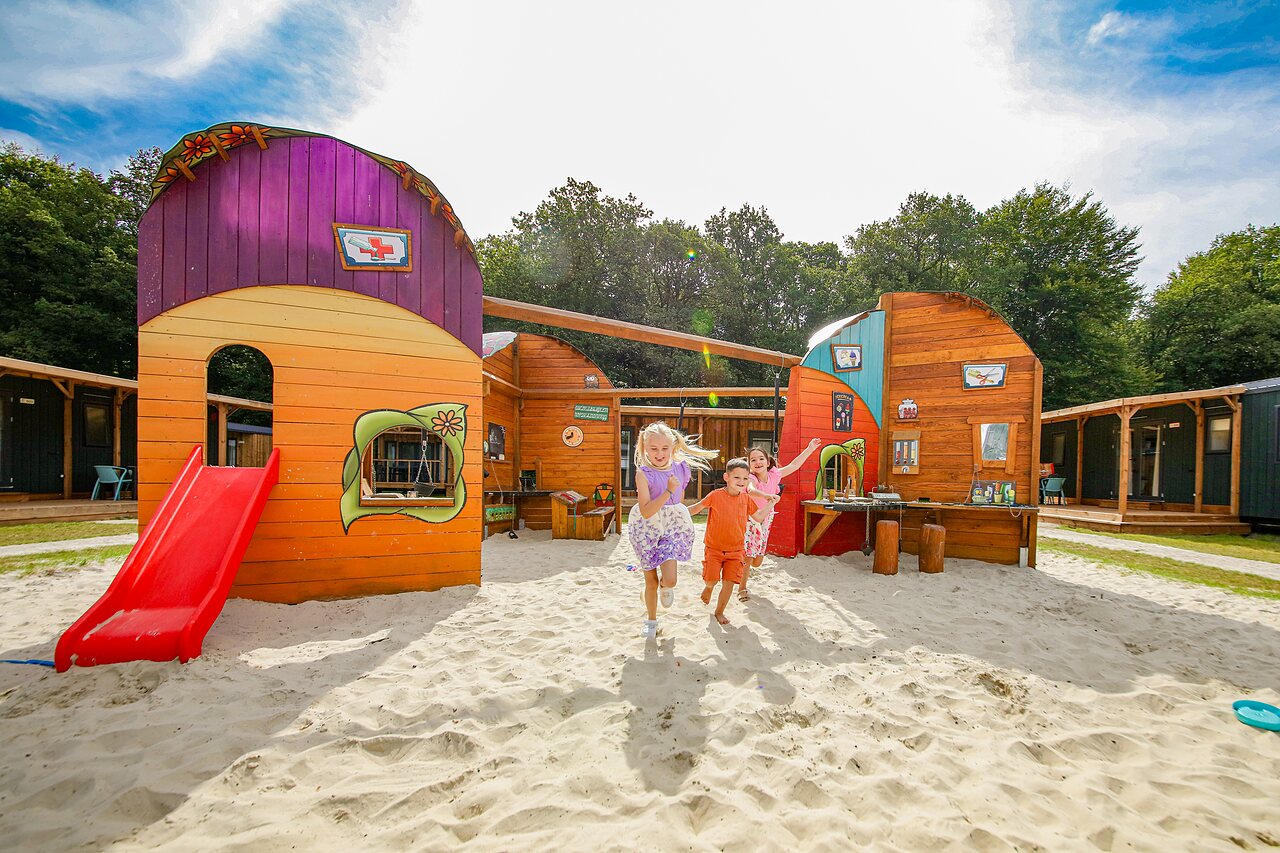 Children playing on the playground with slide, Mobile homes at CAPFUN De Waldsang, Bakkeveen.