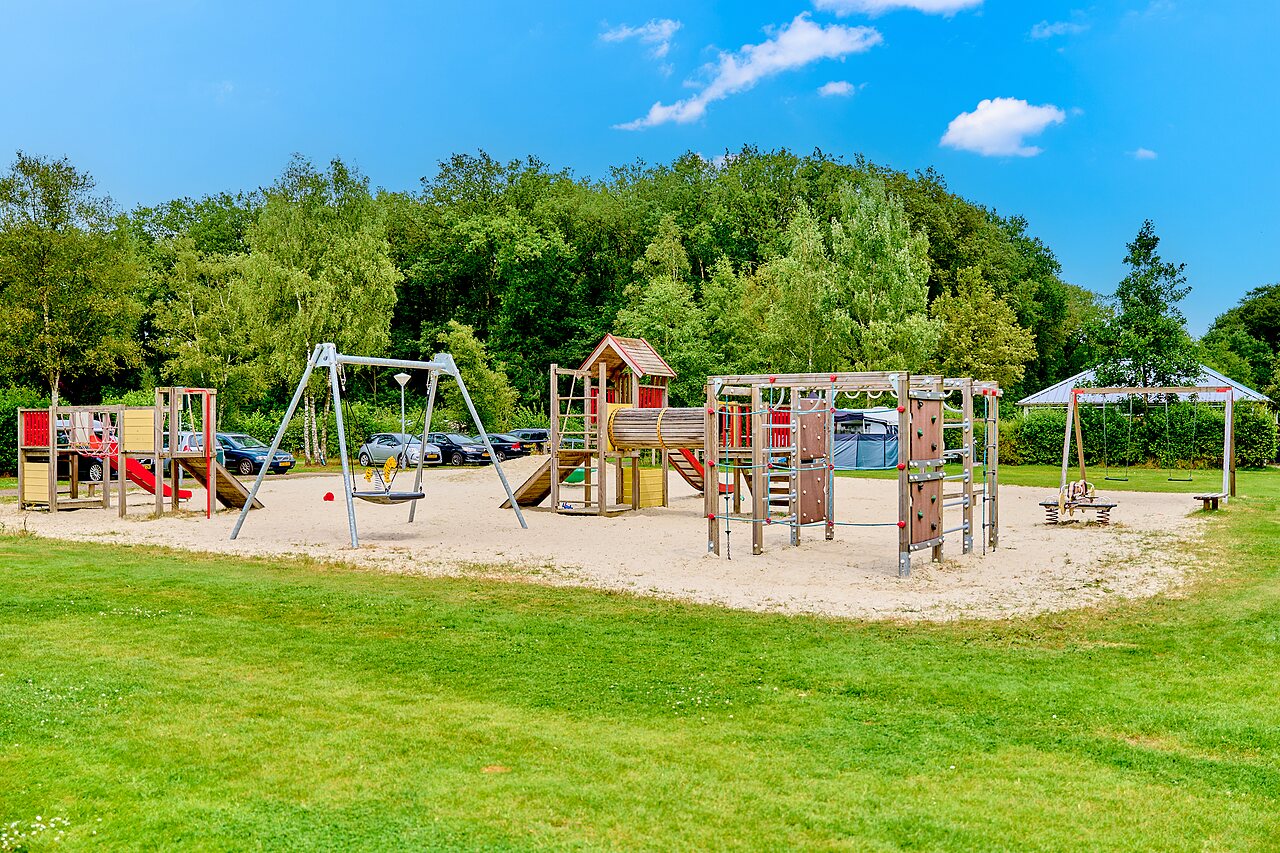 Large playground with swings and slides at CAPFUN De Waldsang campsite in Bakkeveen.