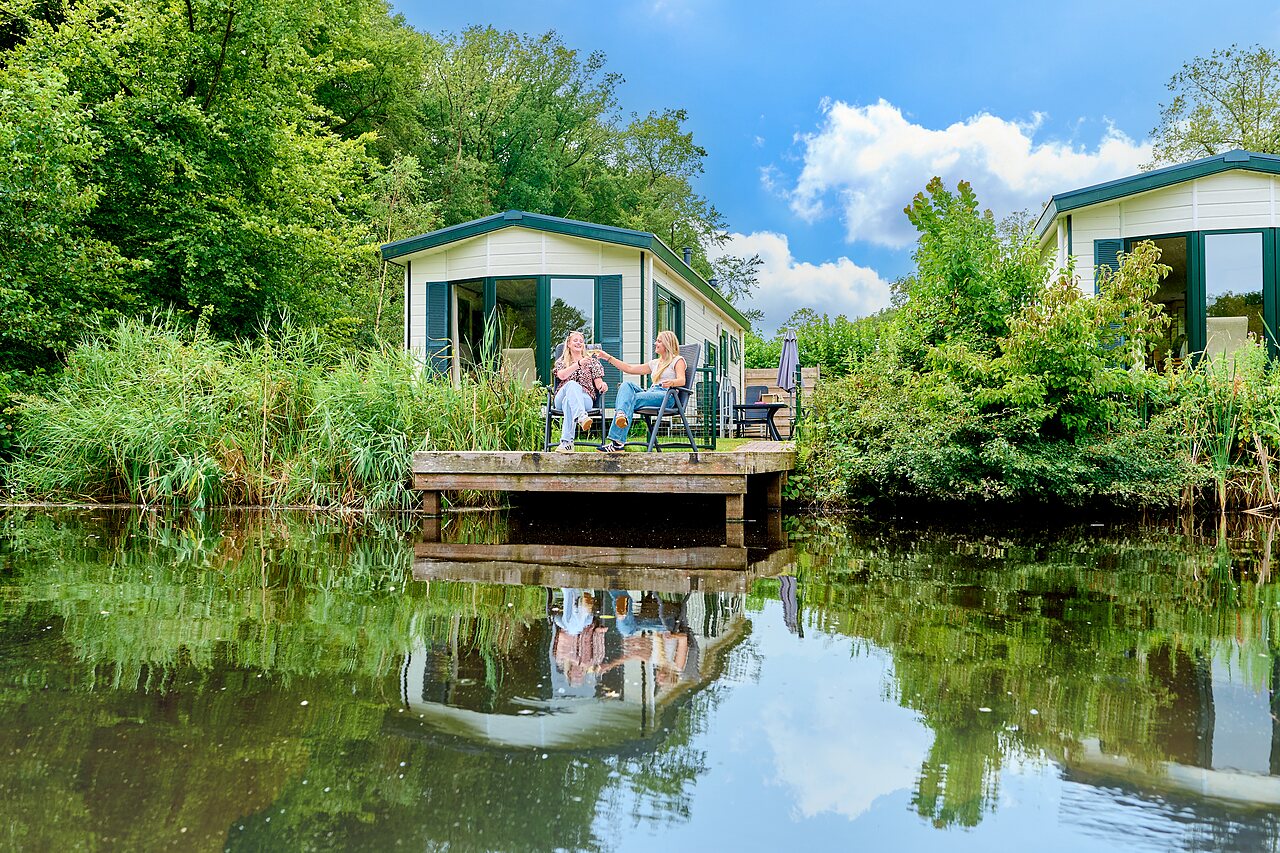 Mobile home, terrace, women, at CAPFUN De Waldsang campsite in Bakkeveen.