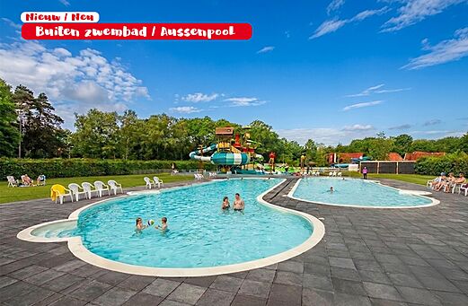 Large outdoor swimming pool with water slides and chairs at CAPFUN het Winkel campsite.