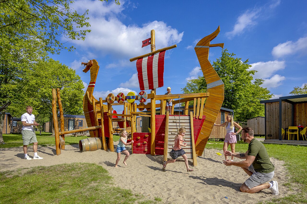 Viking ship playground with children at CAPFUN de Wondermolen campsite in Molenschot.