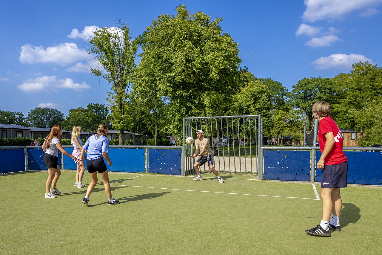 Young people playing football on multisport pitch at CAPFUN Wondermolen, Molenschot.