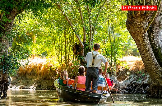 Traditional boat trip through the green canals of the Marais Poitevin.